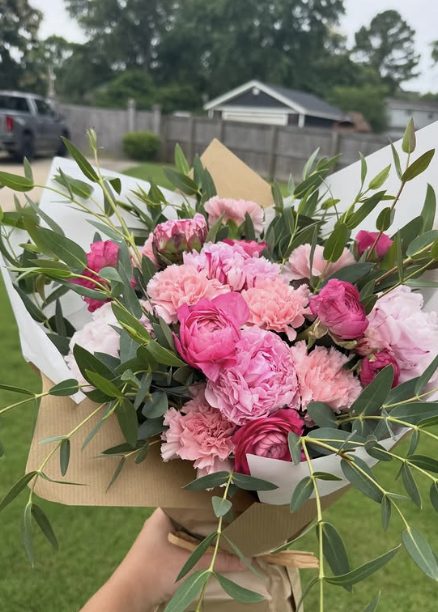 Pink peony and ranunculus bouquet wrapped in kraft paper