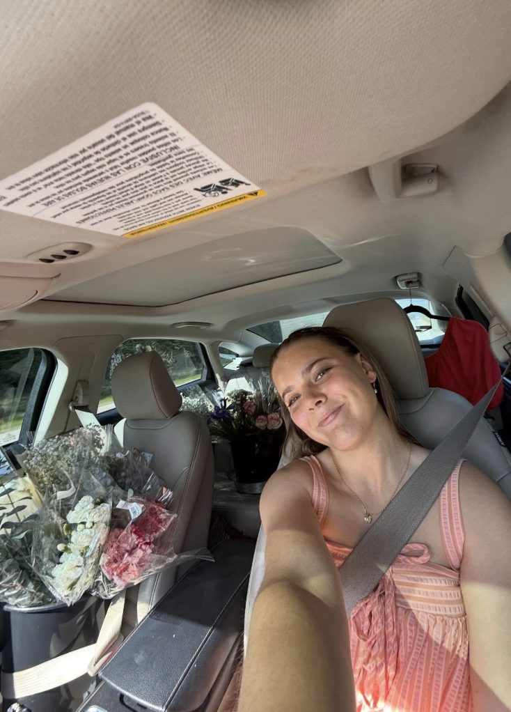 Sydnee Knight, founder of Flowers by Syd, surrounded by fresh flowers